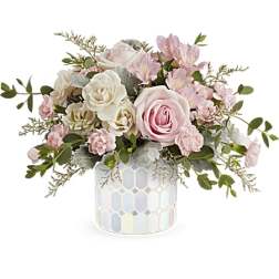 Pink and white roses with small pink blooms in a mosaic vase