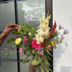 Loose bouquet of mixed pink, cream, and purple flowers