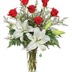 Tall glass vase arrangement with red roses and white lilies
