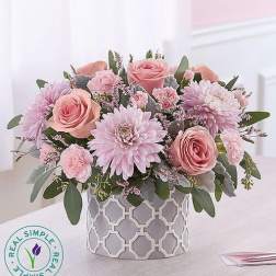 Pink roses and lavender daisies in a patterned vase