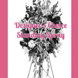 Standing spray on an easel with mixed flowers and greenery