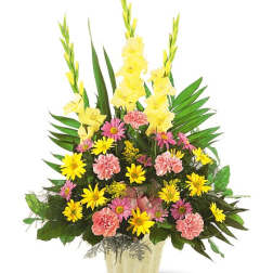 Tall mixed flower arrangement in a gold vase with yellow and pink blooms