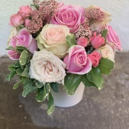 Pink and white rose bouquet in a white vase