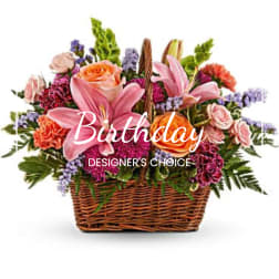 Mixed pink and orange flowers in a wicker basket
