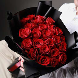 Bouquet of red roses wrapped in black paper