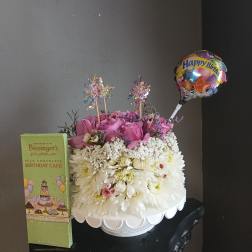 Birthday flower arrangement with a balloon and chocolate box