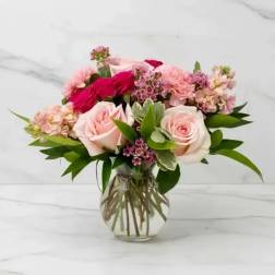 Pink and red rose bouquet in a clear glass vase