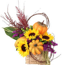 Autumn arrangement with sunflowers and pumpkins in a rustic container