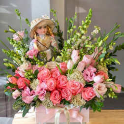 Pink rose bouquet with a doll centerpiece in a pink box