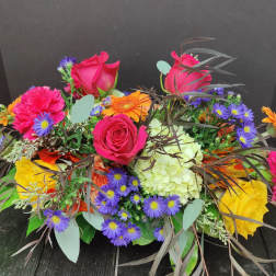 Mixed bouquet with pink roses, purple daisies, and orange gerberas
