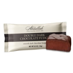 Chocolate fudge candy in a wrapper with a piece shown beside it