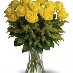 Yellow roses arranged in a clear glass vase