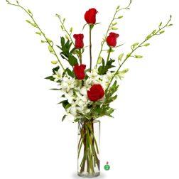 Tall vase arrangement of red roses and white orchids