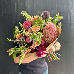 Handheld bouquet with pink hydrangea, peach roses, and purple allium