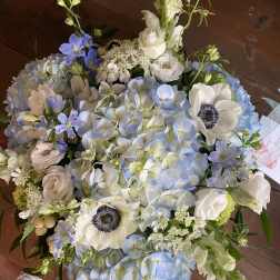 Blue and white bouquet with hydrangeas, anemones, and snapdragons