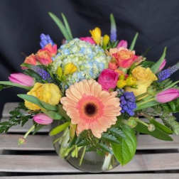 Mixed bouquet with a peach gerbera daisy in a glass vase