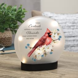 Cardinal memorial light on a black base with floral artwork and text