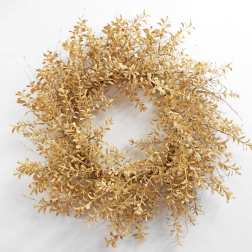 Dried golden wreath with small clustered leaves on a white background