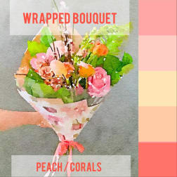 Wrapped bouquet of pink and peach flowers with green foliage