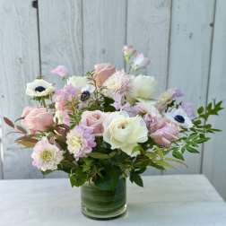 Pastel bouquet of roses and mixed blooms in a clear glass vase