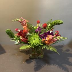 Colorful mixed bouquet in a square glass vase