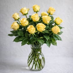 Yellow roses arranged in a clear glass vase