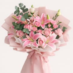 Pink lilies and roses wrapped in pale pink paper