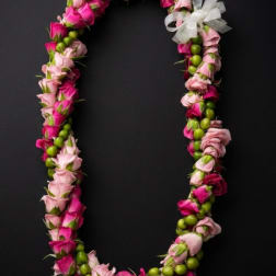 Pink and magenta rose lei with a white ribbon bow