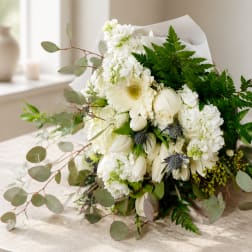 White bouquet with gerbera daisies, roses, and hydrangeas