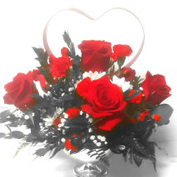 Red roses and carnations in a silver vase with a heart-shaped handle