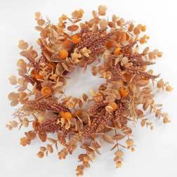 Autumn wreath with orange berries and dried foliage on a white background