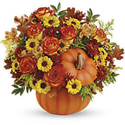 Pumpkin-shaped vase filled with orange roses and yellow daisies