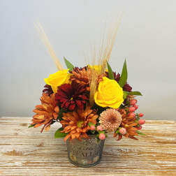 Fall bouquet in a decorative metal pot with yellow roses and orange chrysanthemums