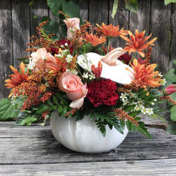 Pumpkin-shaped vase with orange and pink flowers