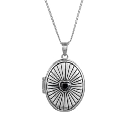 Silver locket necklace with a black heart center on a white background
