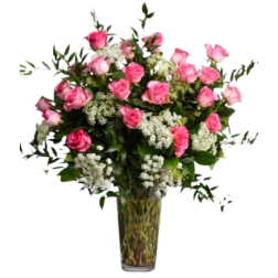 Tall glass vase arrangement with pink roses and white accent flowers