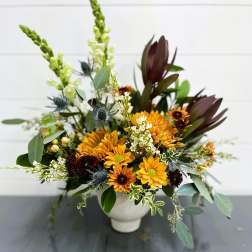 Mixed bouquet in a white vase with yellow and burgundy flowers