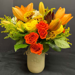 Orange and yellow bouquet in a beige vase