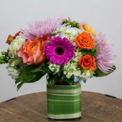 Colorful mixed bouquet in a striped glass vase