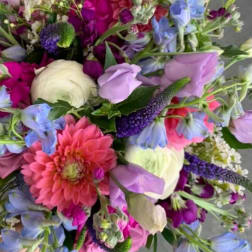 Colorful mixed bouquet with pink dahlia, white ranunculus, lavender blooms and blue flowers