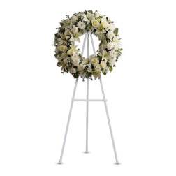 White floral wreath on a standing easel