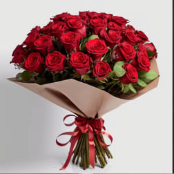 Bouquet of red roses wrapped in beige paper with a red ribbon