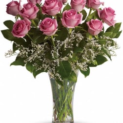 Pink roses arranged in a clear glass vase