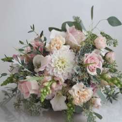 Soft pink and white bouquet with roses, calla lilies, and a central dahlia