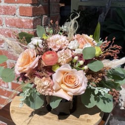 Peach and blush rose bouquet with eucalyptus in a black container