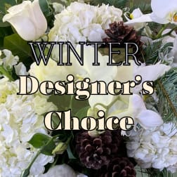 White floral arrangement with pinecones and evergreen accents