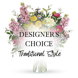Mixed bouquet in a clear glass vase with pink, yellow, white, and purple flowers
