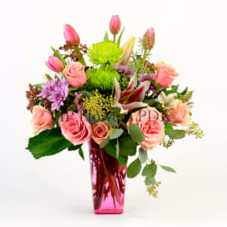 Pink and peach mixed bouquet in a tall pink vase