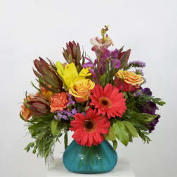 Colorful mixed bouquet in a turquoise glass vase