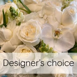 White roses and orchids in a close-up floral arrangement